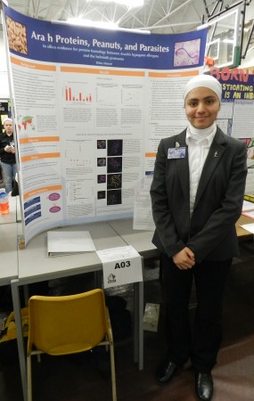 Eisha Ahmed (Abbey Park High School, Oakville) presents her award winning poster "Ara h Proteins, Peanuts, and Parasites". Eisha was the winner of the IIDR summer studentship and will be back at McMaster learning bioinformatics this summer.