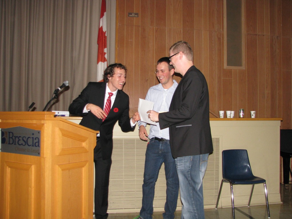 Kyle Novakowski (PhD candidate) receives his award for the best poster award as chosen by the audience.